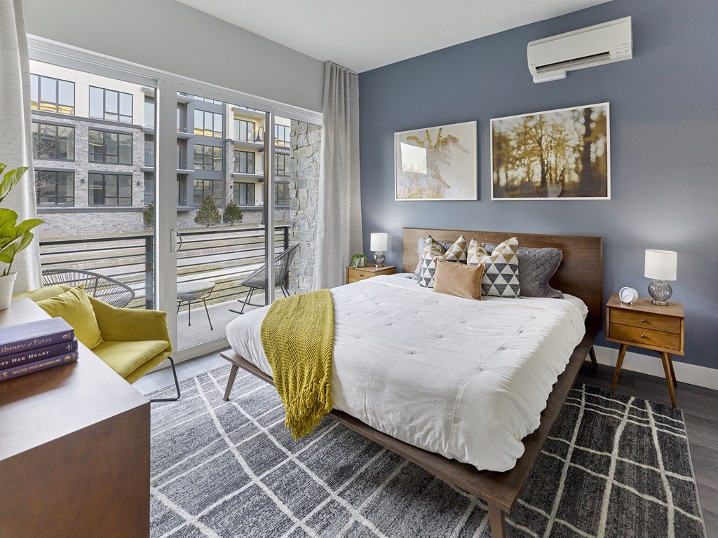a bedroom with a large bed and a balcony