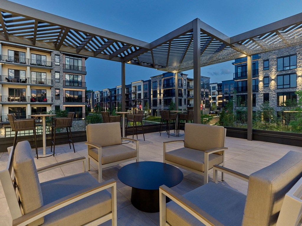 a patio with chairs and a table on a