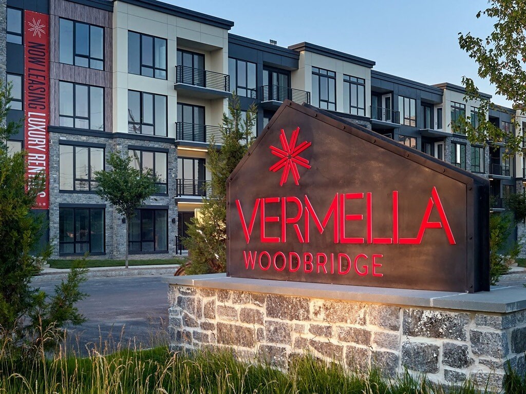 a sign for vermella woodbridge in front of an apartment building