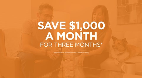 A man and a woman sitting on a couch with a dog, with text offering a savings deal.