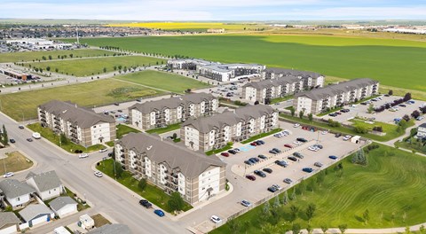 A large apartment complex with lots of parking