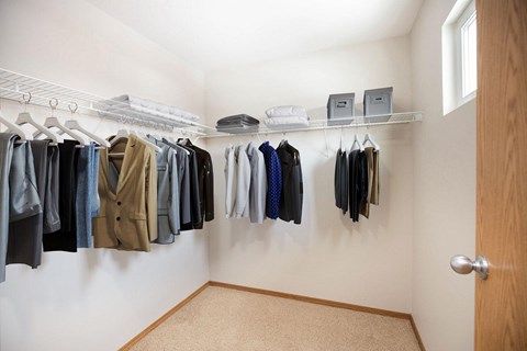 A white wall with clothes hanging on it.