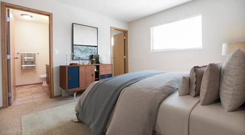 A bedroom with ensuite bathroom and walk in closet