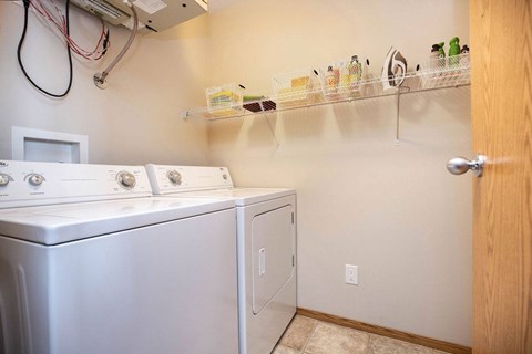 A small laundry room with a washer and dryer.