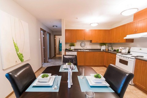 A modern dining room with a table set for two.