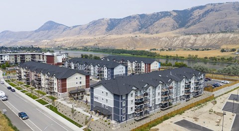 A very large apartment complex set against the mountains
