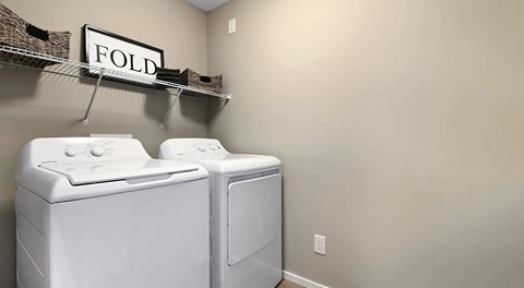 A laundry room with a washer and dryer