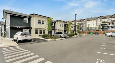 A row of townhomes with parking in front