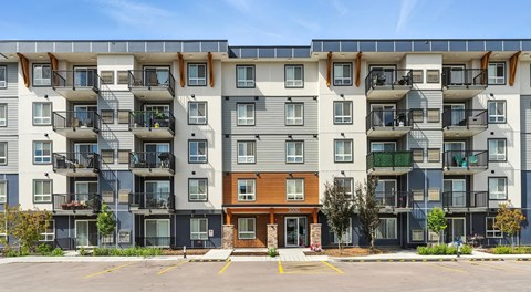 large modern apartment building with parking out front
