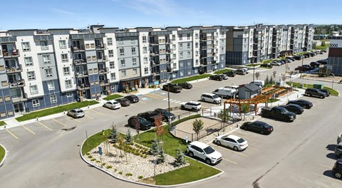 A large apartment complex with lots of parking in front