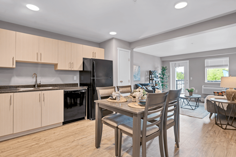 A kitchen with a table and chairs in the middle of the room.