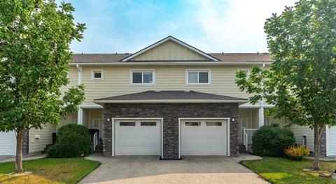 Two townhouses with single car garage and driveway