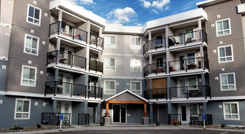 A large apartment complex with balconies and doors.
