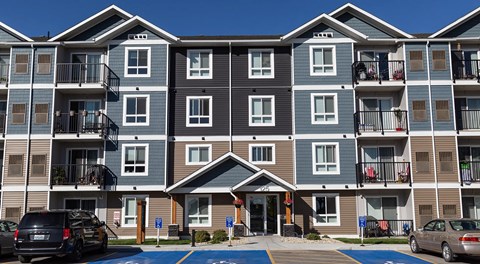 A large modern apartment building with balconies and lots of windows