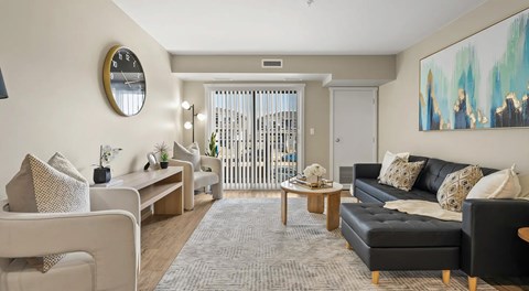 A open living room with a sectional, chairs, coffee table with a glass sliding door