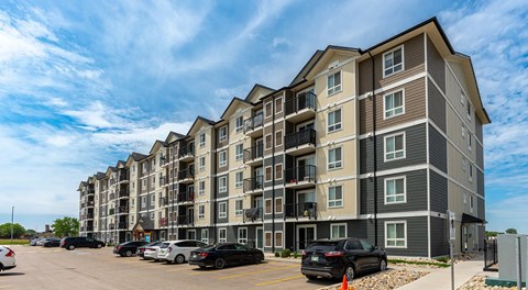 A large apartment building with parking in front