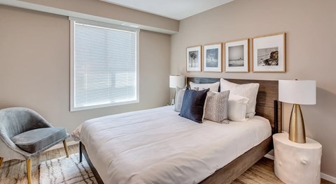 A bedroom with a large bed and window