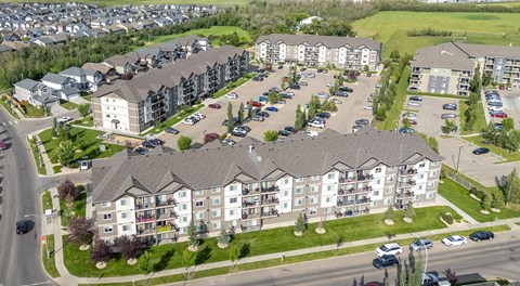 A large apartment complex with lots of parking