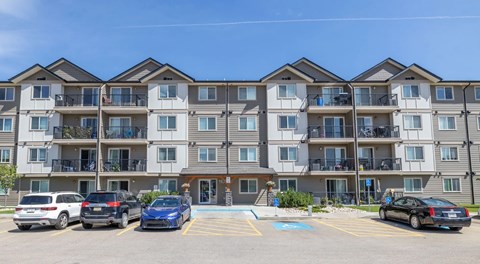 A large apartment building with parking out front