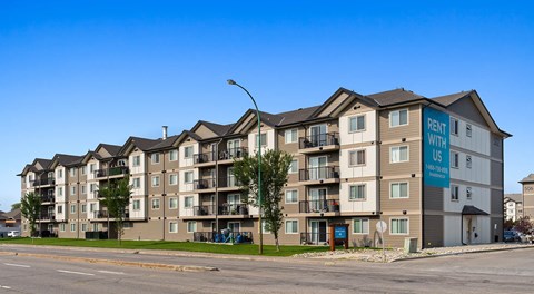 An apartment building with parking behind