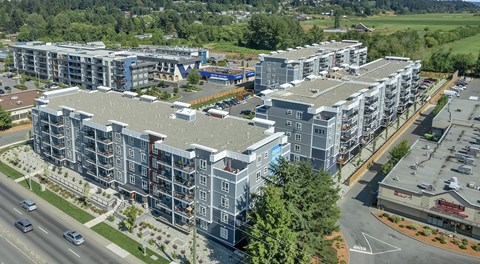A large apartment complex next to a shopping centre