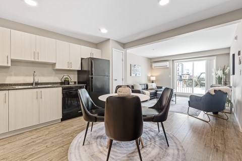 A modern kitchen with a dining table and chairs.