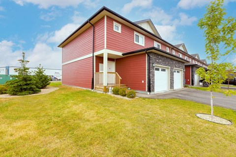 A red house with a white door and windows.