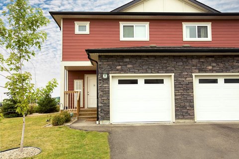 A red house with a white garage door.