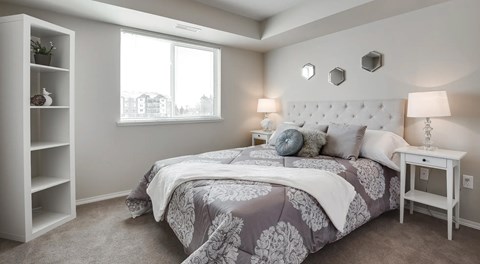 A bedroom with a large bed and a window.