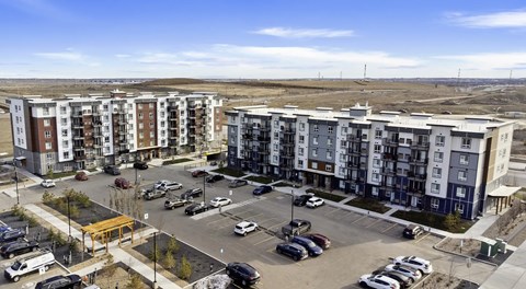 Multi building apartment complex with parking lot along side and in front of the buildings