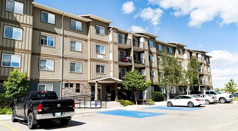 An apartment building with parking out front