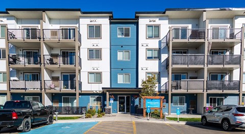 A modern apartment building with parking out front