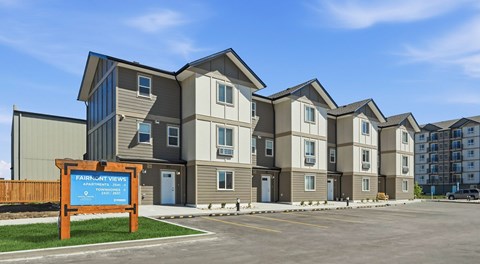 A row of townhomes with parking out front