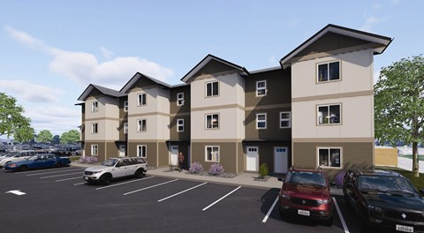 A row of townhouses with cars parked in front.