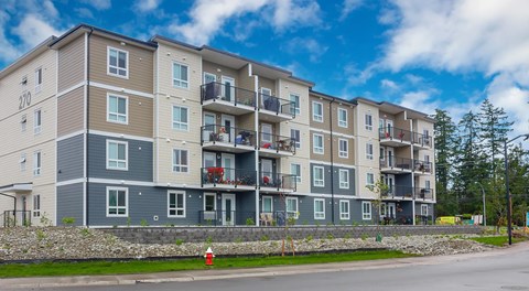 A large apartment building with balconies and lots of windows