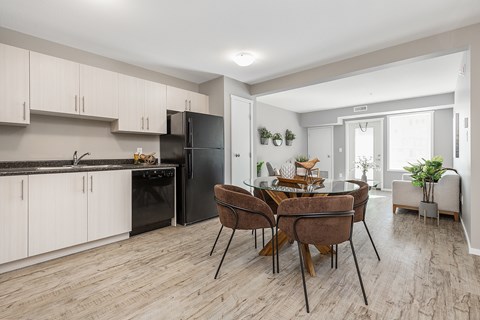 A modern kitchen with a dining table set for four.