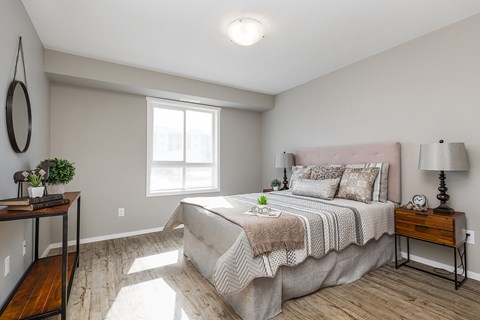 A bedroom with a large bed and a wooden table.