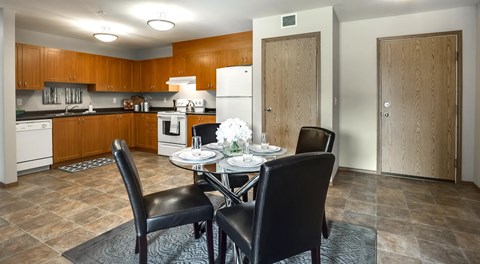 Large open kitchen with brown wooden cabinets and white appliances
