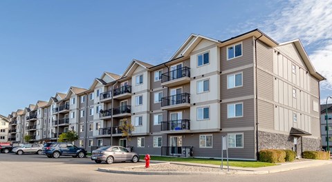 A large apartment building with parking out front