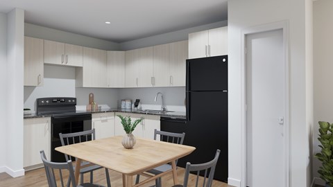 A kitchen with a black refrigerator and a wooden dining table with grey chairs.