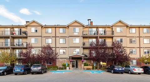 A large apartment building with parking out front