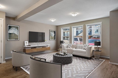 A living room with a grey sofa and a coffee table.