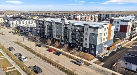 Five storey apartment building with street parking out front