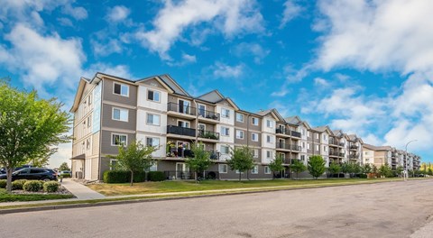 Four storey apartment building with street parking