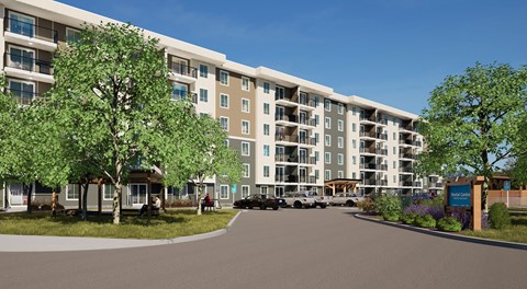A large apartment complex with a parking lot in front.