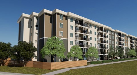 A modern apartment building with balconies and trees in front.