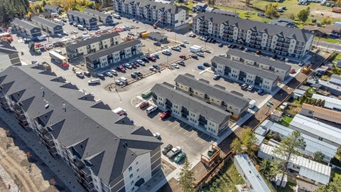 A bird's eye view of a parking lot surrounded by buildings.