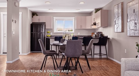 A modern kitchen and dining area with a table set for four.