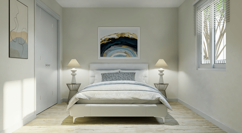 A bedroom with a large bed and a painting on the wall.