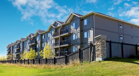A modern apartment building next to a field